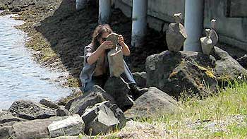 Man piling rocks. (novala) Man piling rocks. (novala)